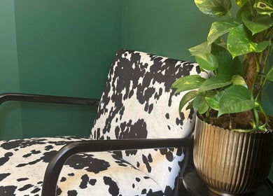 Modern chair with cow print and green plant at Sophie Knight Studio, Hereford, England, GB.