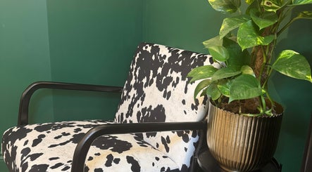 Modern chair with cow print and green plant at Sophie Knight Studio, Hereford, England, GB.