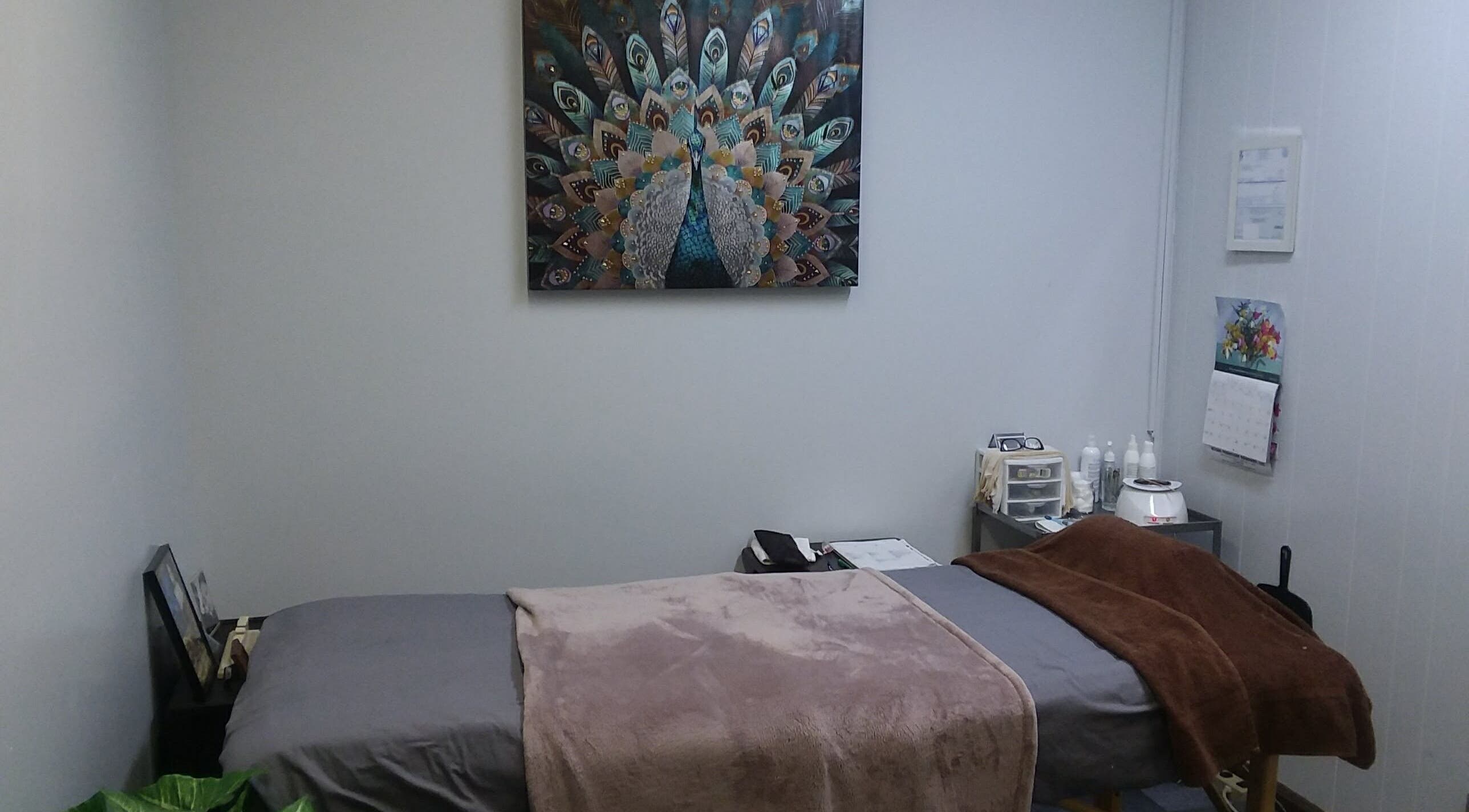 Relaxing treatment room at Waxing by Keisha ☆ in Hampton, Virginia, US, with cozy bed and tranquil decor.