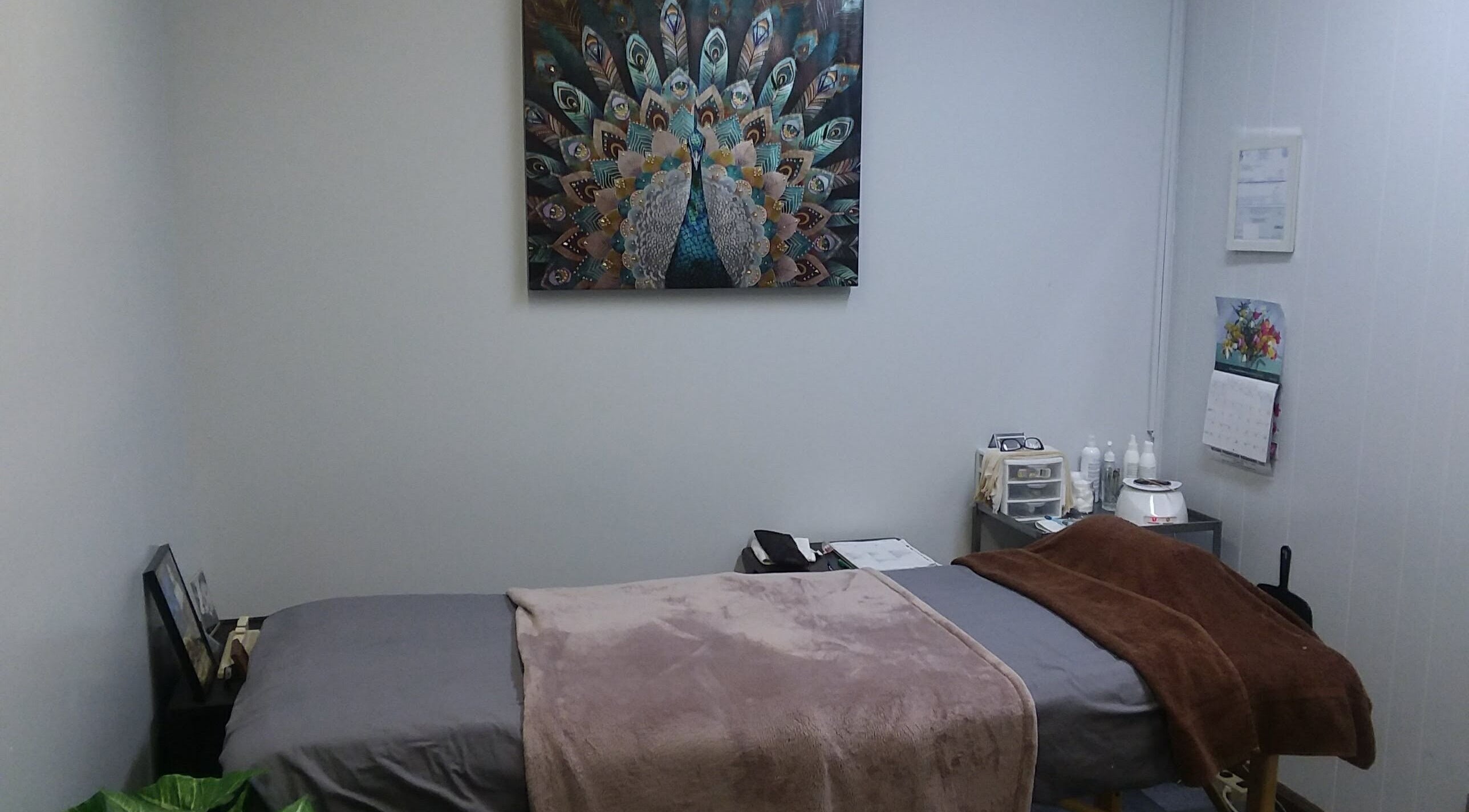 Relaxing treatment room at Waxing by Keisha ☆ in Hampton, Virginia, US, with cozy bed and tranquil decor.