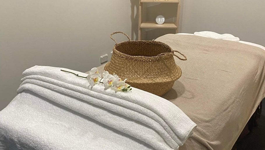 Lux Thai massage room with soft towels and orchids in Forde, Australian Capital Territory, AU.