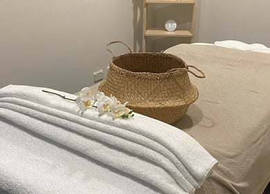 Lux Thai massage room with soft towels and orchids in Forde, Australian Capital Territory, AU.
