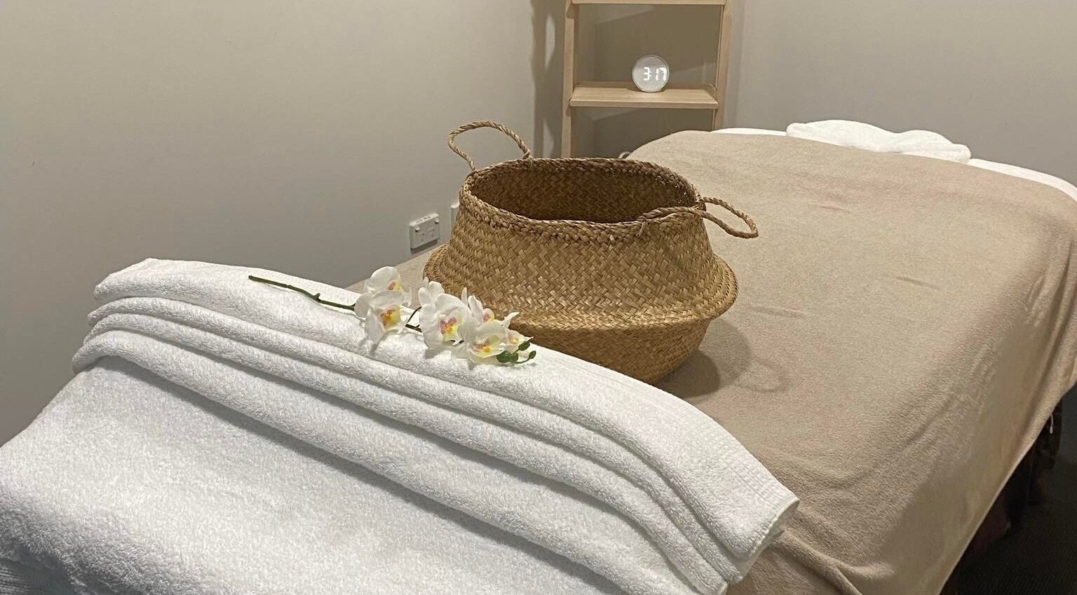 Lux Thai massage room with soft towels and orchids in Forde, Australian Capital Territory, AU.