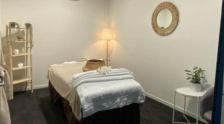 Cozy spa room at Lux Thai in Forde, Australian Capital Territory, AU with massage table and calming decor.