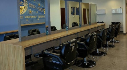 Interior view of Champions Barbering Institute in Portland, Oregon, US, showcasing salon chairs and mirrors.