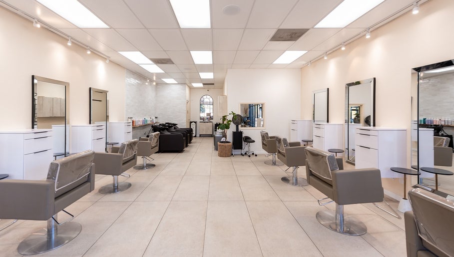Modern Salon Ardor interior in San Diego, California with stylish chairs and mirrors.