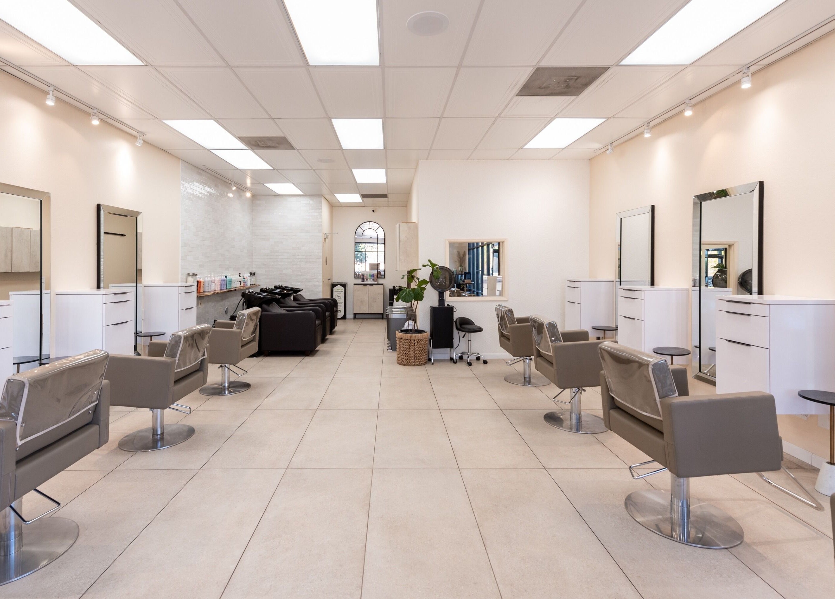 Modern Salon Ardor interior in San Diego, California with stylish chairs and mirrors.