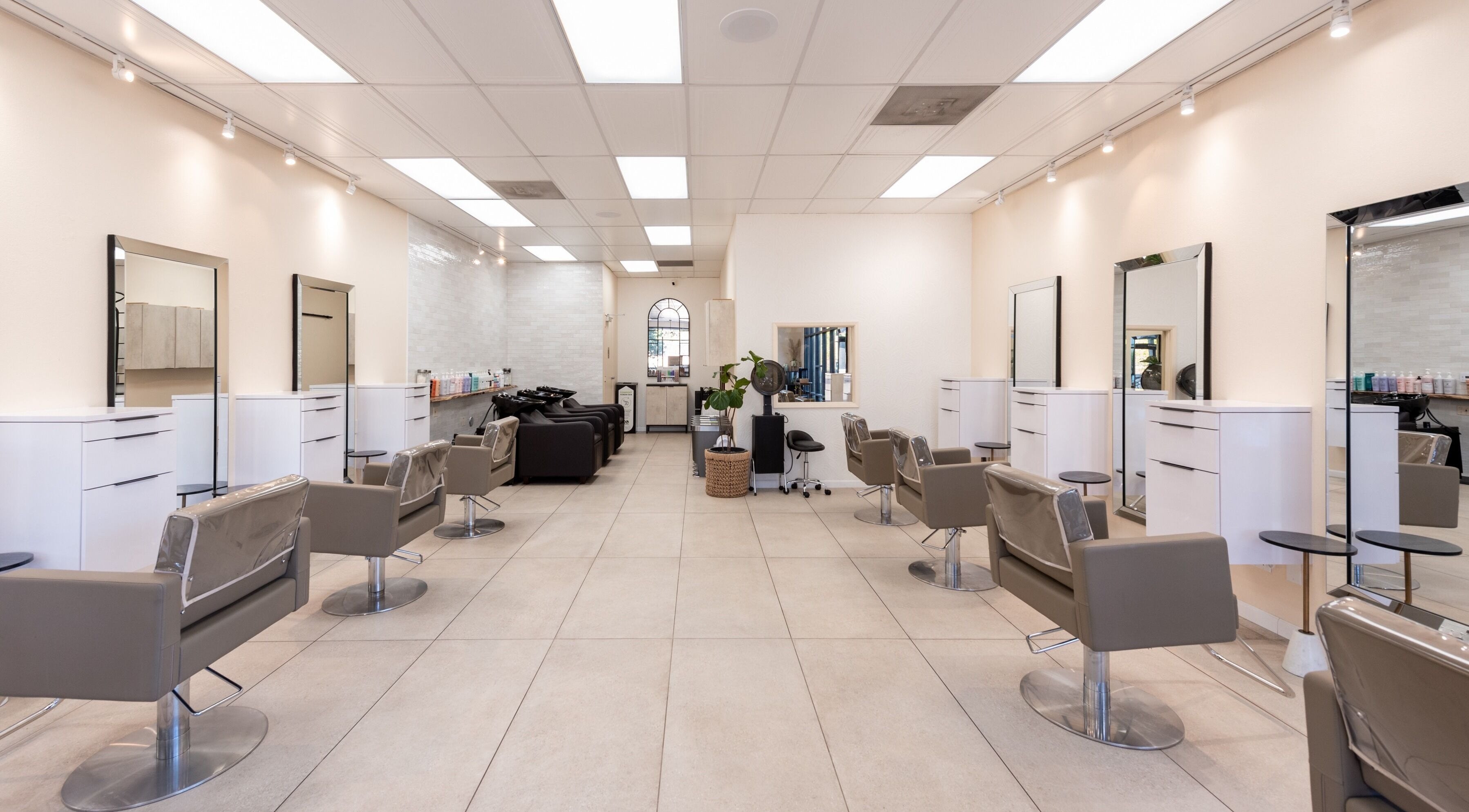 Modern Salon Ardor interior in San Diego, California with stylish chairs and mirrors.