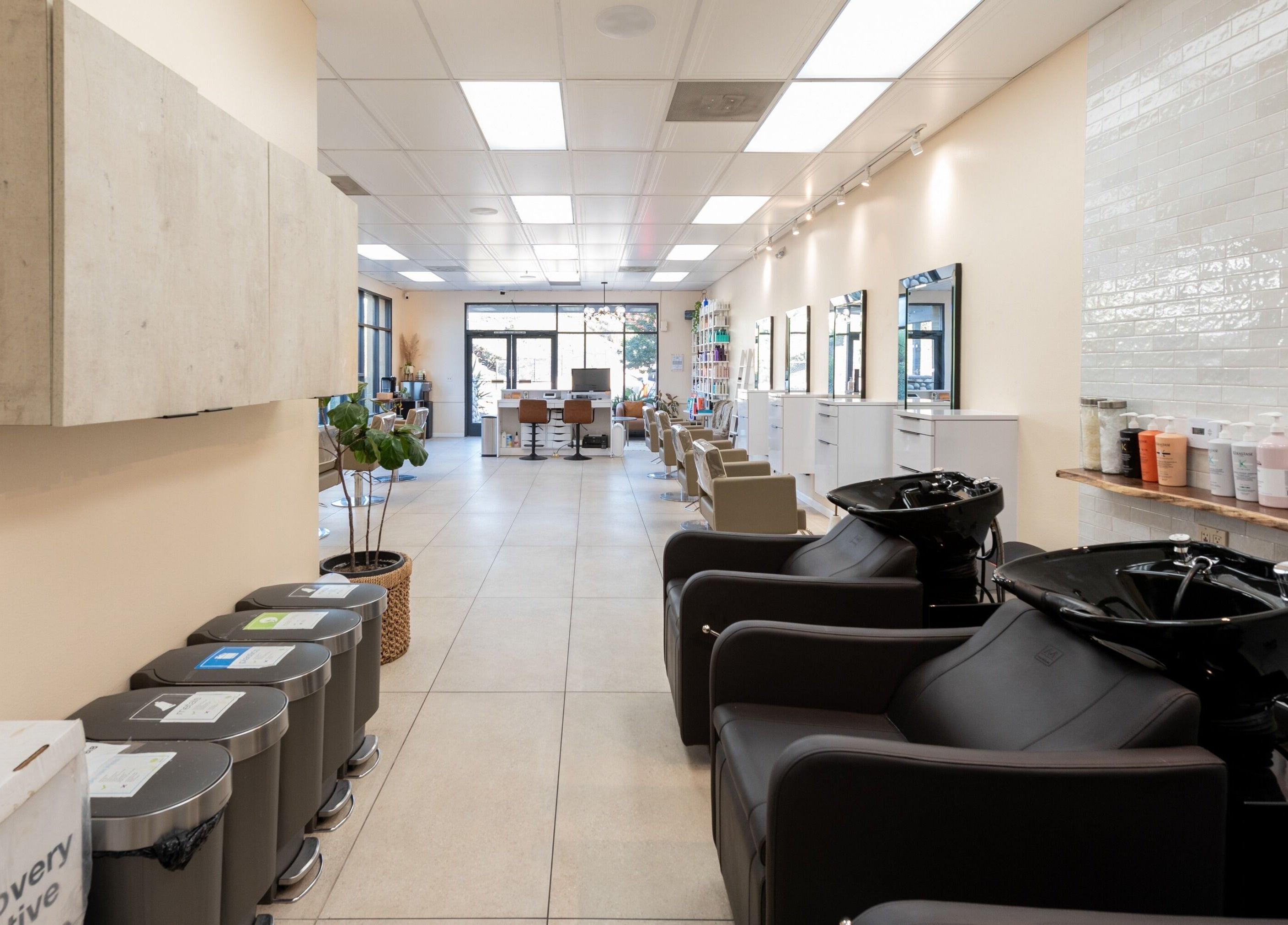 Modern interior of Salon Ardor in San Diego, California, US featuring sleek styling stations and wash basins.