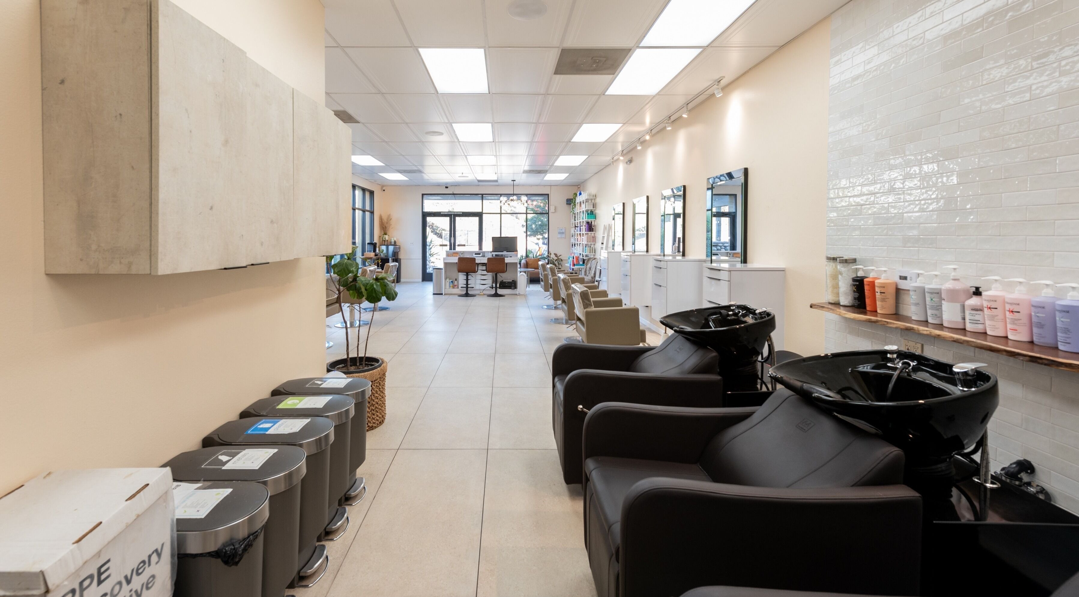 Modern interior of Salon Ardor in San Diego, California, US featuring sleek styling stations and wash basins.