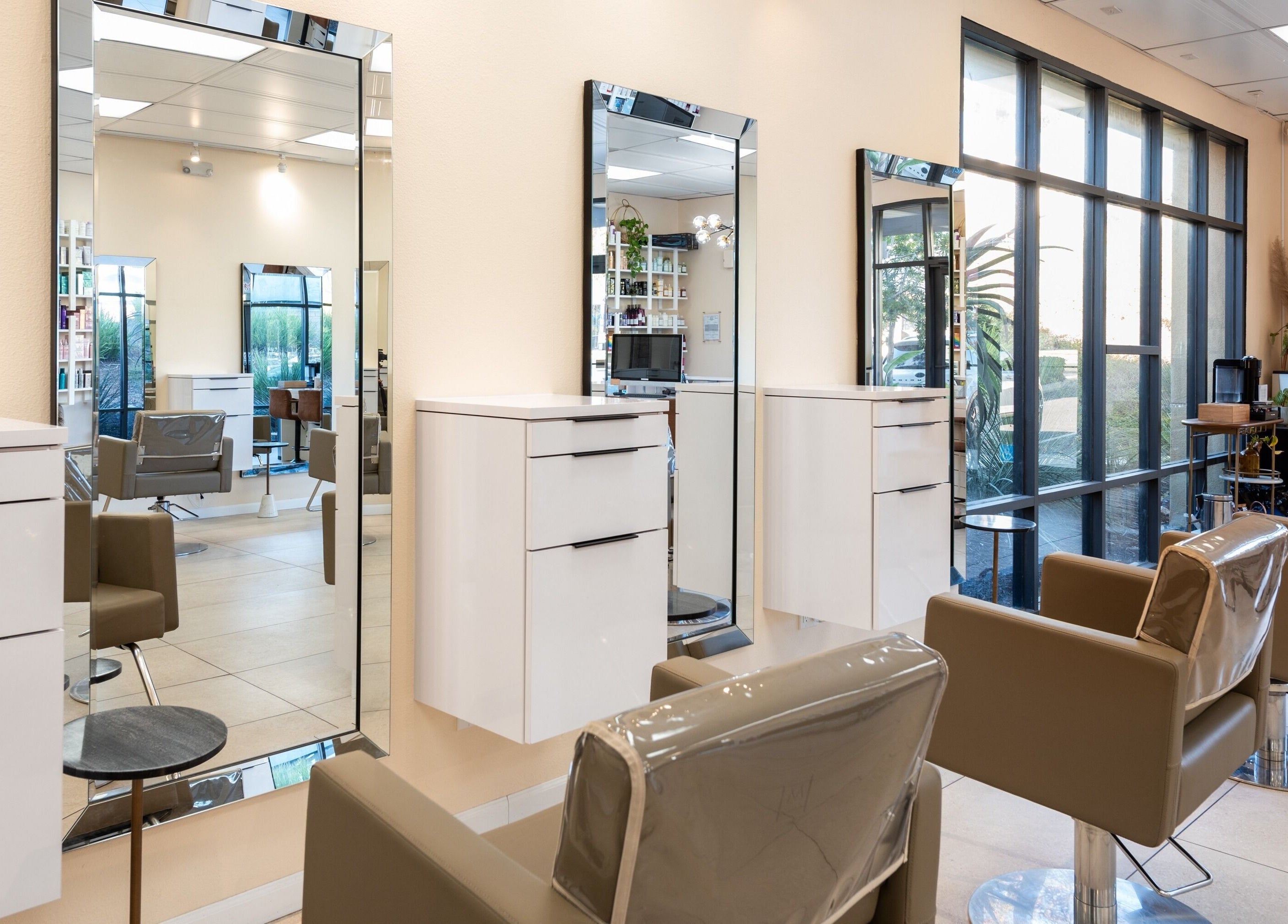 Modern interior of Salon Ardor in San Diego, California, US with sleek styling chairs and large mirrors.
