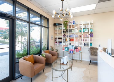 Elegant interior of Salon Ardor in San Diego, California, US, featuring modern seating and product shelves.