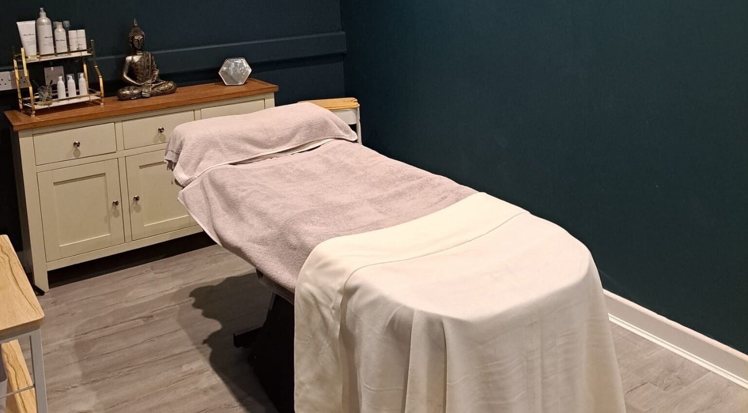 Calm treatment room at Bespoke Beauty SP, Newton-Le-Willows, England, GB with a massage table and relaxing decor.