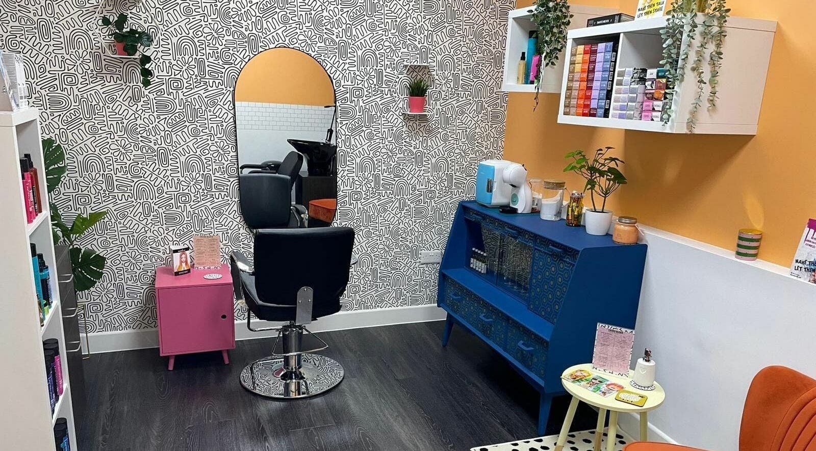 Vibrant interior of Cheeky Bleach Hair Boutique in Manchester, England, GB with stylish decor and seating.