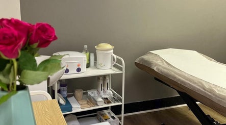 Spa treatment room at Skimprove in London, England, GB with a massage table and beauty products.