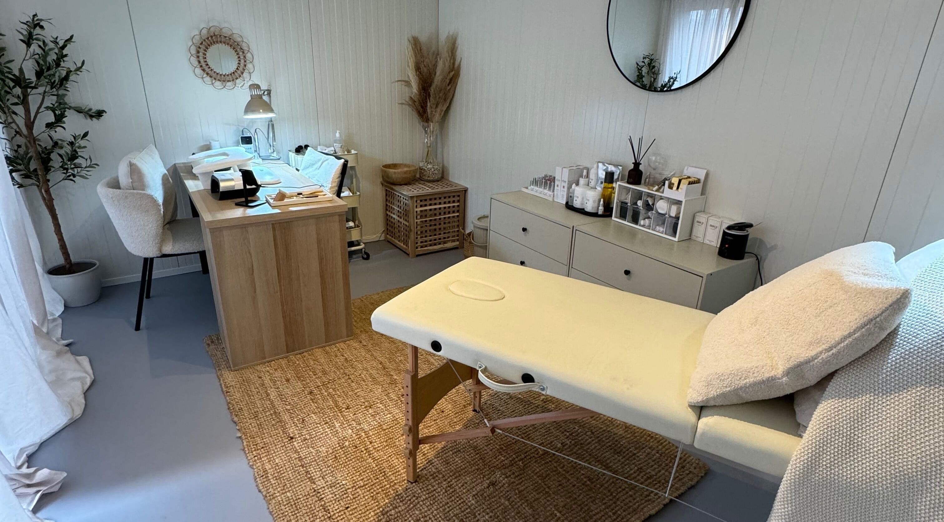 Relaxing spa room at Freodom Studio, Mountsorrel, England, GB, featuring a massage table and natural decor.