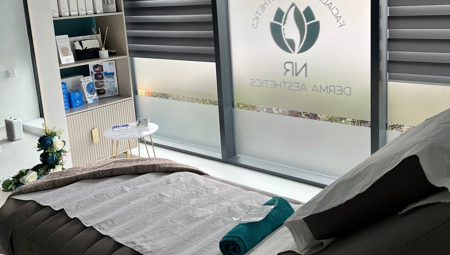 Relaxing treatment room at NR Derma Aesthetics, Bicester, England, GB showcasing a tranquil setup.