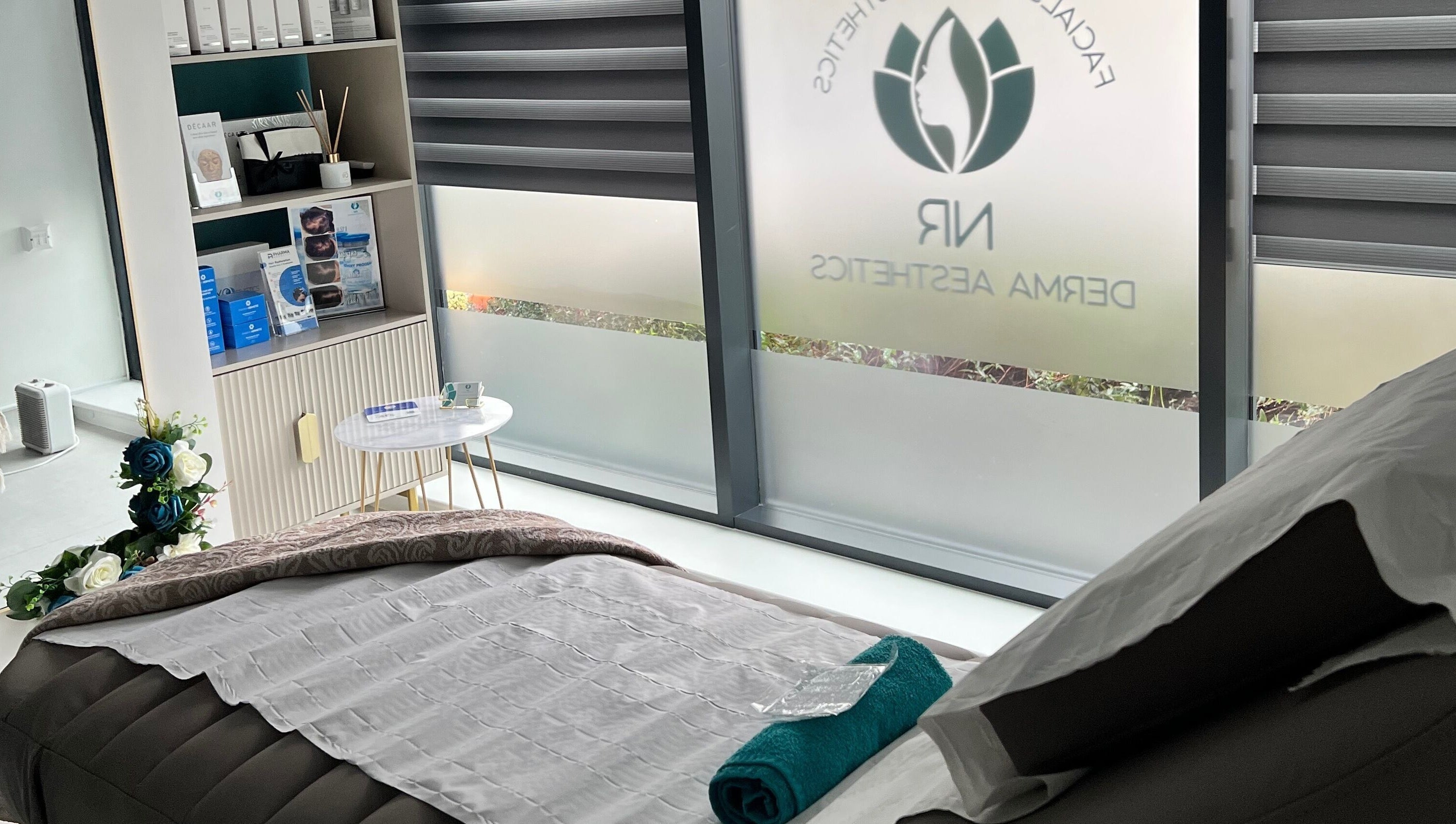 Relaxing treatment room at NR Derma Aesthetics, Bicester, England, GB showcasing a tranquil setup.