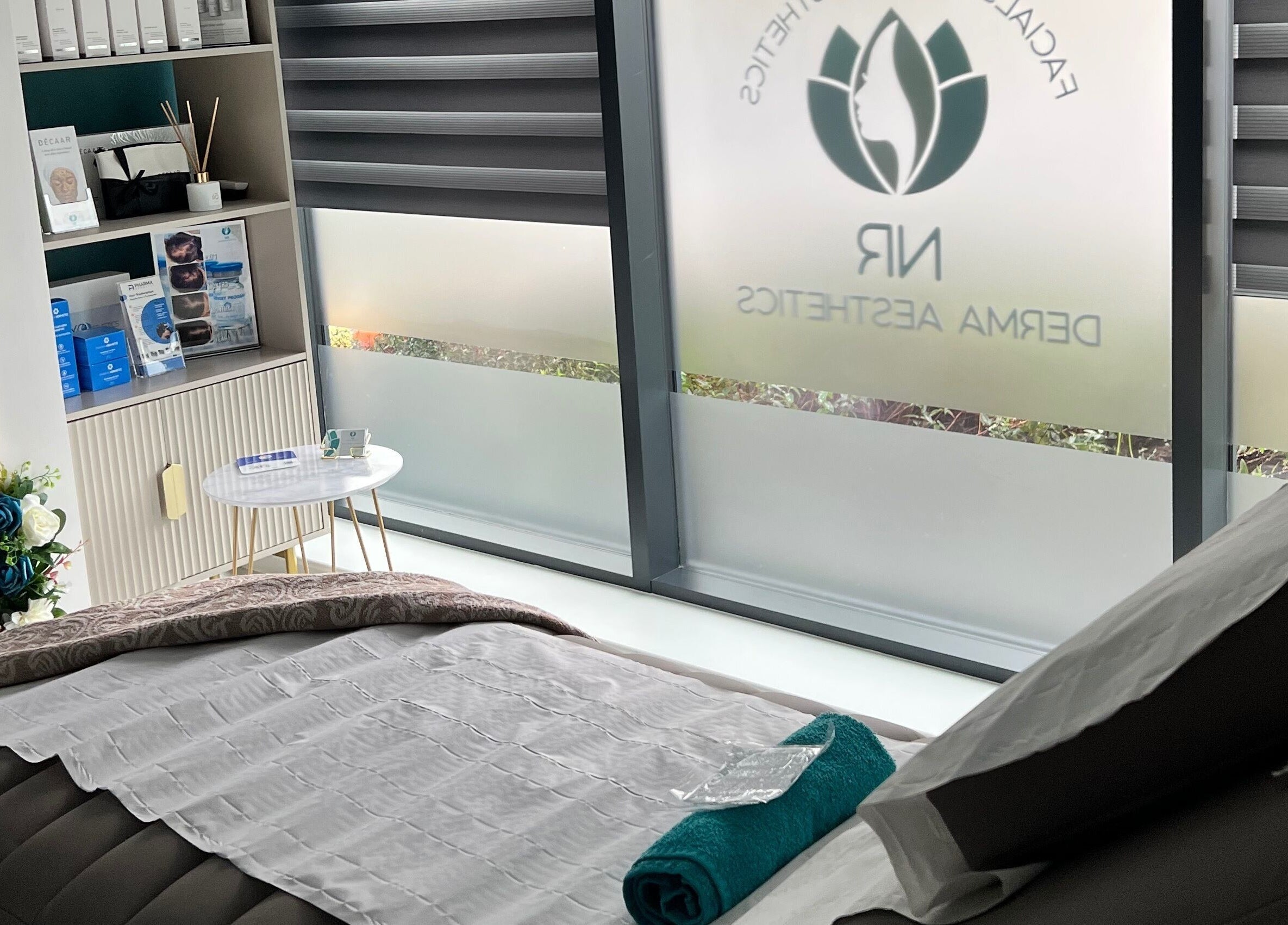 Relaxing treatment room at NR Derma Aesthetics, Bicester, England, GB showcasing a tranquil setup.