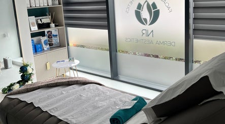 Relaxing treatment room at NR Derma Aesthetics, Bicester, England, GB showcasing a tranquil setup.