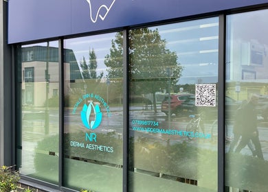 Exterior of NR Derma Aesthetics in Bicester, England showcasing modern design and clear branding.
