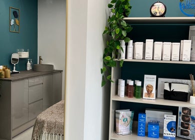 NR Derma Aesthetics in Bicester, England, GB: calming treatment room with products and modern decor.