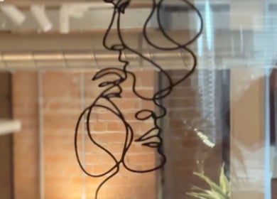 Artistic wire face sculpture at Smile Aesthetics by Jamie, Cardiff, Wales, GB, showcases unique decor.