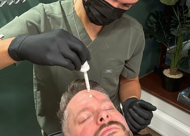 Practitioner at Smile Aesthetics by Jamie in Cardiff, Wales, GB, applying skincare treatment.