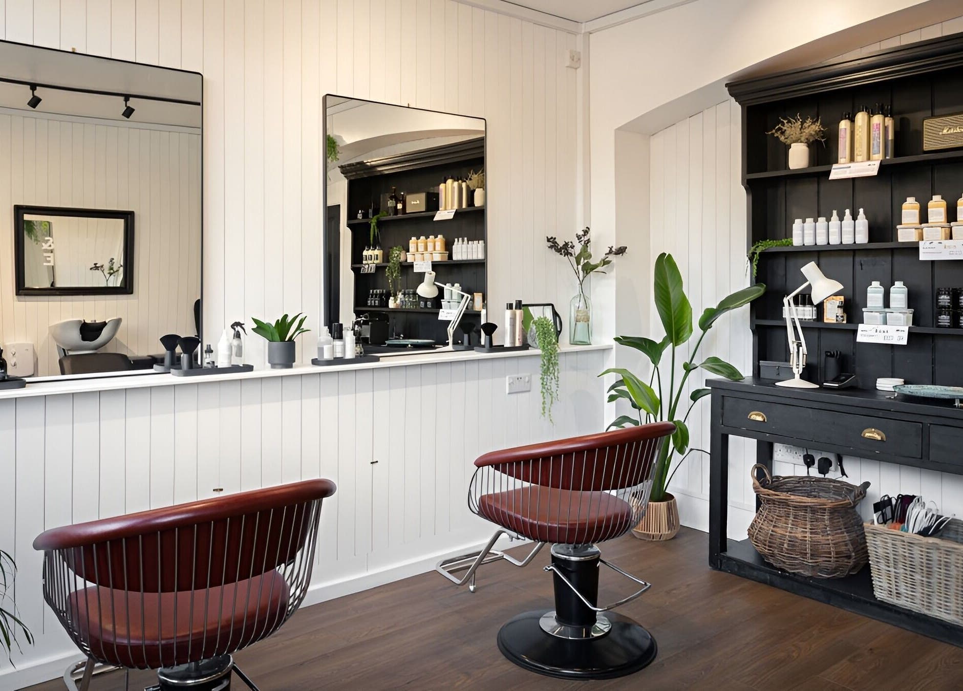 Modern salon at Rose and Rogue, Sevenoaks, England. Elegant chairs and beauty products create a welcoming ambiance.