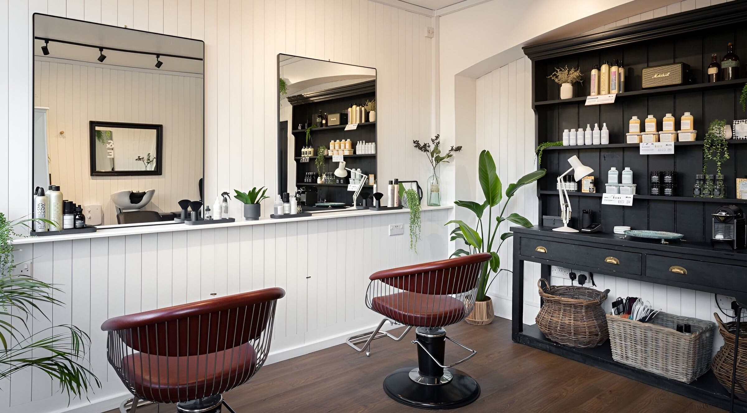 Modern salon at Rose and Rogue, Sevenoaks, England. Elegant chairs and beauty products create a welcoming ambiance.