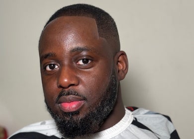 Man with fresh haircut at LM CUTZ, London, England, GB. Emphasizing style and grooming.
