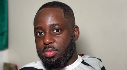 Man with fresh haircut at LM CUTZ, London, England, GB. Emphasizing style and grooming.