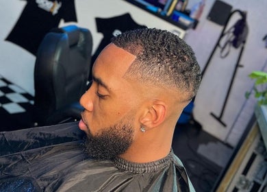 Sharp fade haircut at LM CUTZ, London, England, GB. Modern barber shop interior in view.