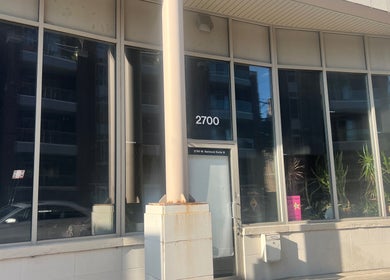 Exterior view of Beauty Culture Avondale at 2700 W Belmont, Chicago, Illinois, US, showcasing modern glass facade.