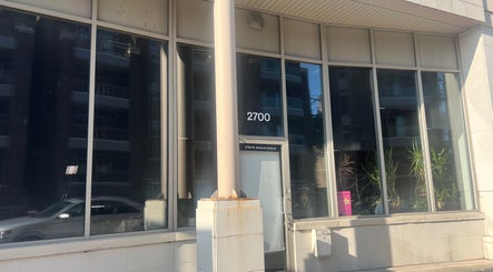 Exterior view of Beauty Culture Avondale at 2700 W Belmont, Chicago, Illinois, US, showcasing modern glass facade.