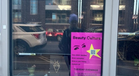 Reflection in Beauty Culture Avondale window, showcasing services in Chicago, Illinois, US.