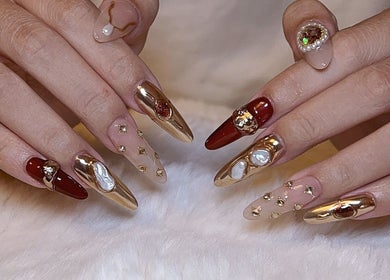 Intricate gold and red nail art at Jenn Gel Nail Studio, Rowley Regis, England, GB.