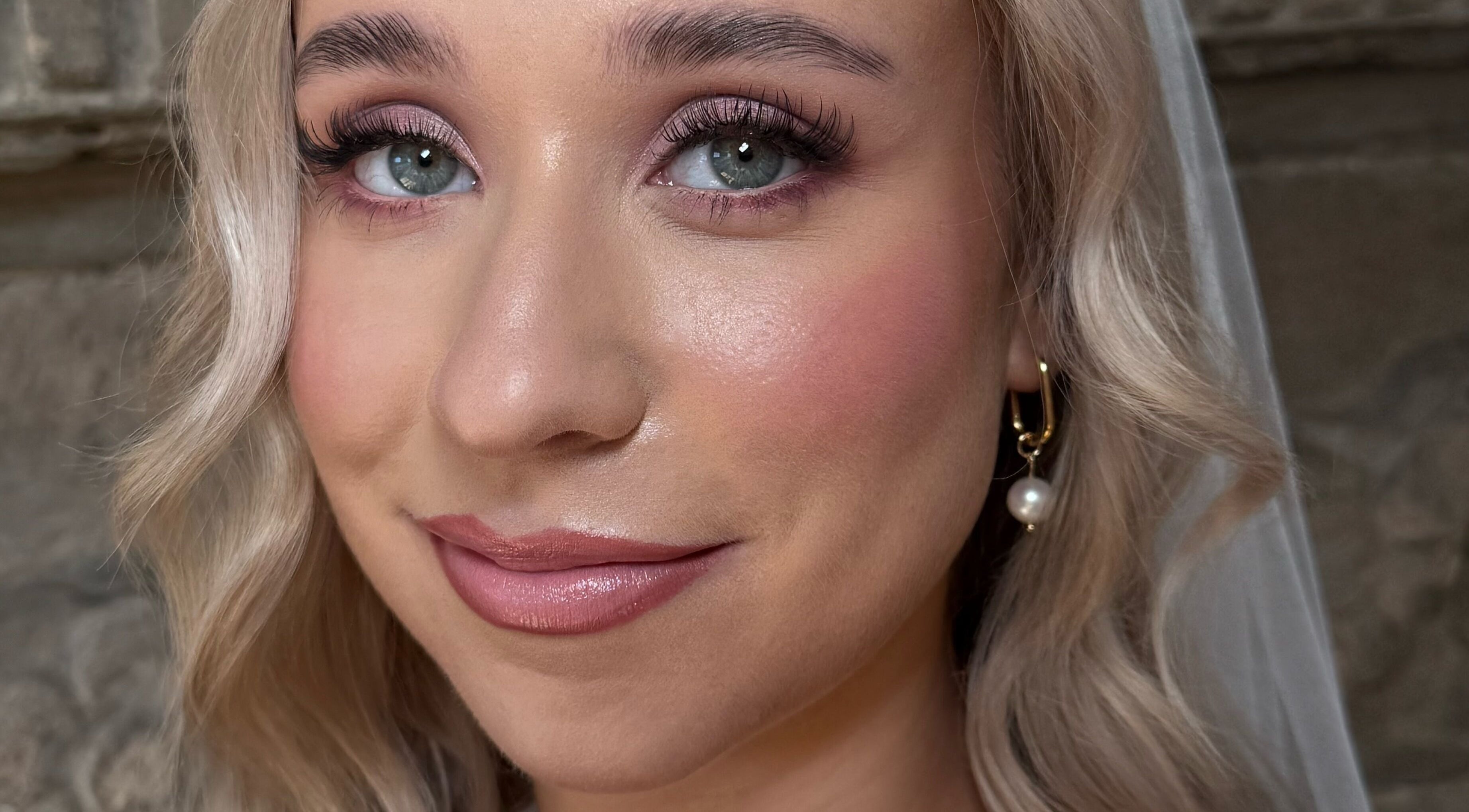 Bridal makeup by Heather Connor at Elevate, Linlithgow, Scotland, GB. Flawless complexion with soft curls.