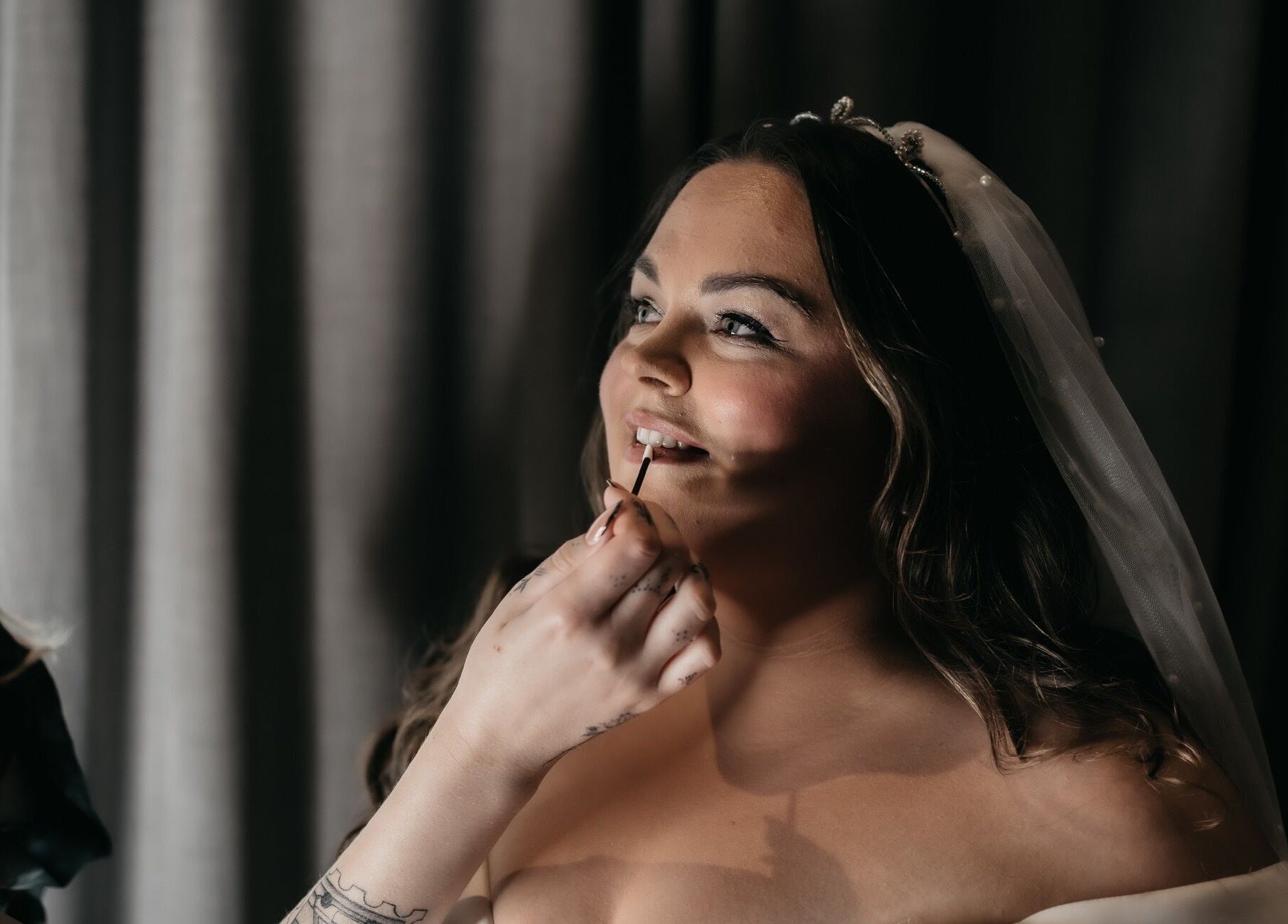 Bride having makeup applied, radiating joy by Heather Connor at Elevate, Linlithgow, Scotland, GB.