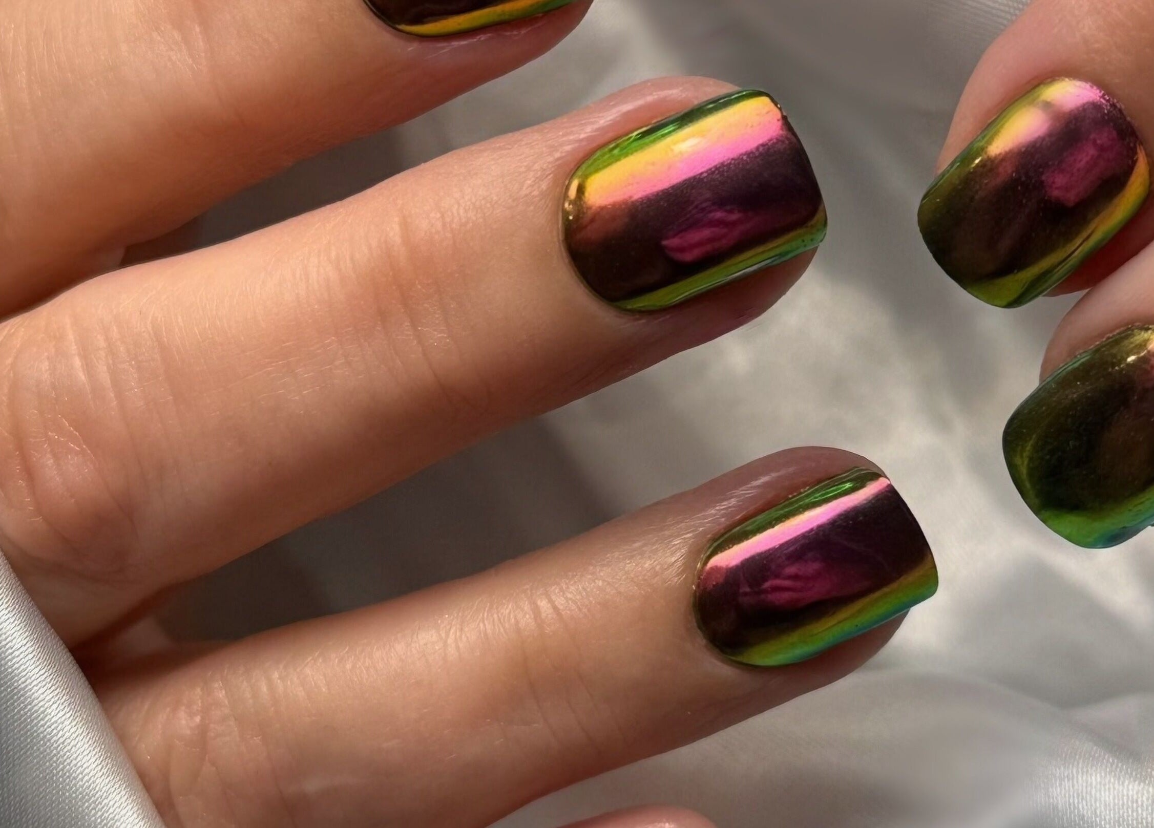 Shimmering iridescent nails by Heather Connor at Elevate, Linlithgow, Scotland, GB on a silk background.