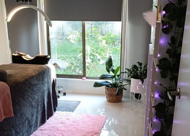 Relaxing interior of Lash Artistry by RK in Buttaba, New South Wales, AU. Elegant decor with cozy treatment bed.