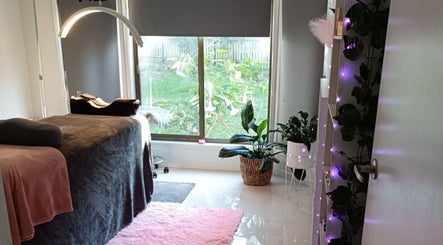 Relaxing interior of Lash Artistry by RK in Buttaba, New South Wales, AU. Elegant decor with cozy treatment bed.