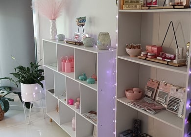 Chic display shelves at Lash Artistry by RK, Buttaba, New South Wales, AU showcasing beauty products.