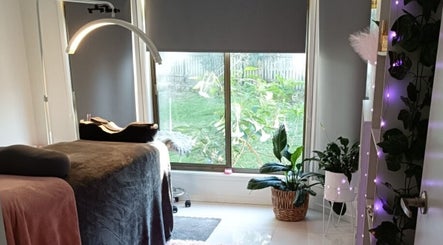 Tranquil interior of Lash Artistry by RK, Buttaba, New South Wales, featuring a treatment bed and green plants.