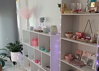 Elegant product shelves at Lash Artistry by RK, Buttaba, New South Wales, AU, showcasing beauty essentials.