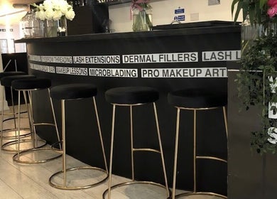 Elegant interior of Navs Beauty Clapham, London, England, GB with sleek bar seating and stylish decor.