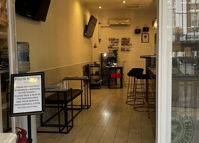 Inviting interior of Navs Beauty Clapham in London, England, GB, showcasing a warm, welcoming seating area.