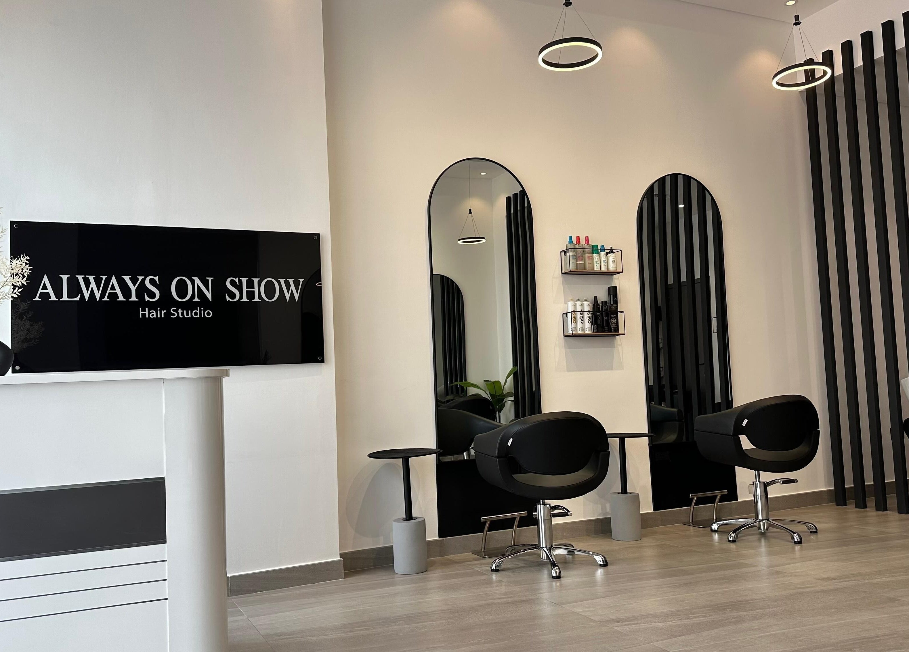 Elegant interior of Always On Show Hair Studio in Dubai, قرية جميرا الدائرية, AE showcasing modern salon chairs.