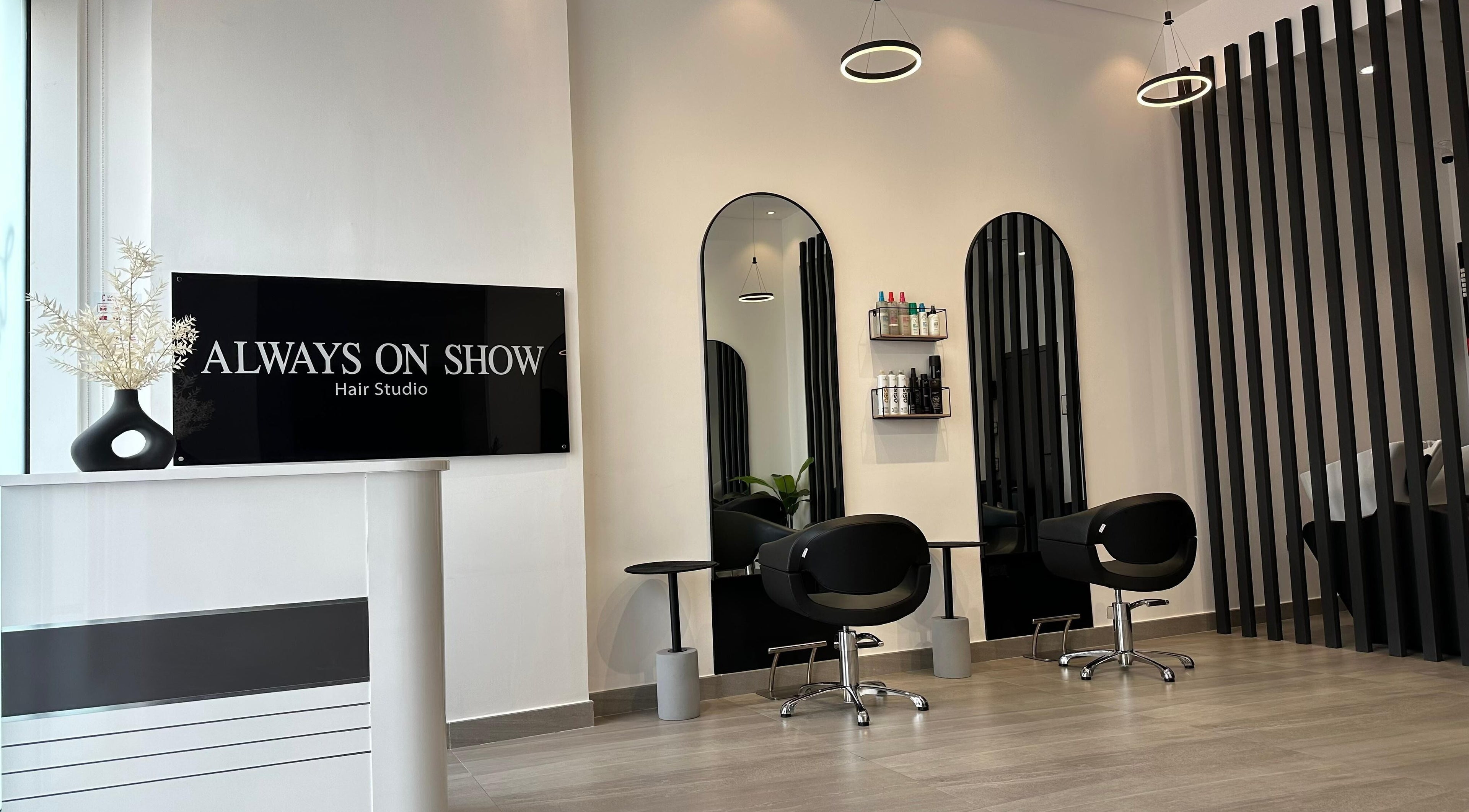 Elegant interior of Always On Show Hair Studio in Dubai, قرية جميرا الدائرية, AE showcasing modern salon chairs.