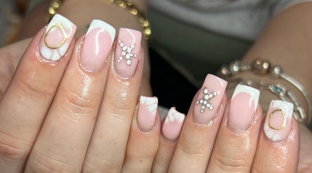 Elegant pink and white nail art at PopsBeautyStudio, Gwent, Wales, GB, showcasing intricate designs.